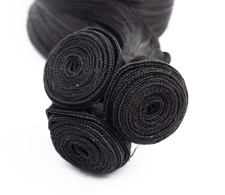 Bundles of Brazilian spiral curl human hair extensions.