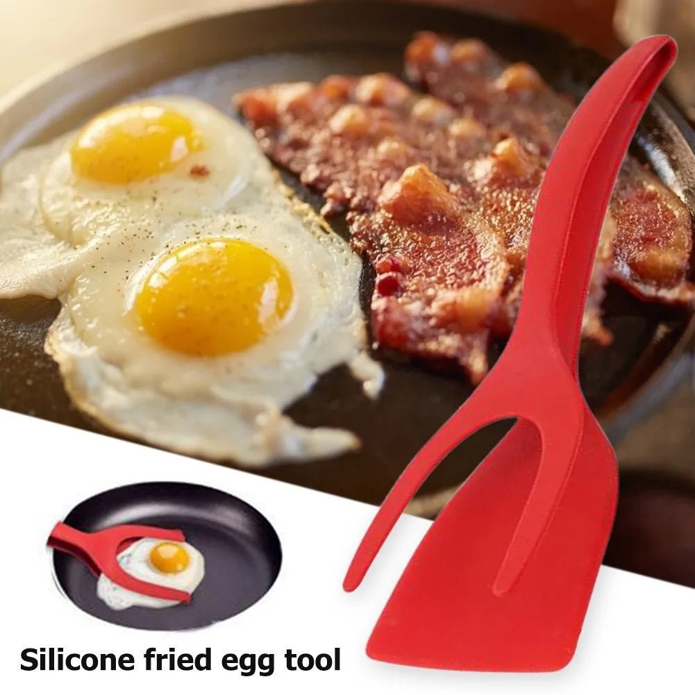 Red 2-in-1 spatula tongs flipping eggs and bacon on a griddle, kitchen cooking utensil.