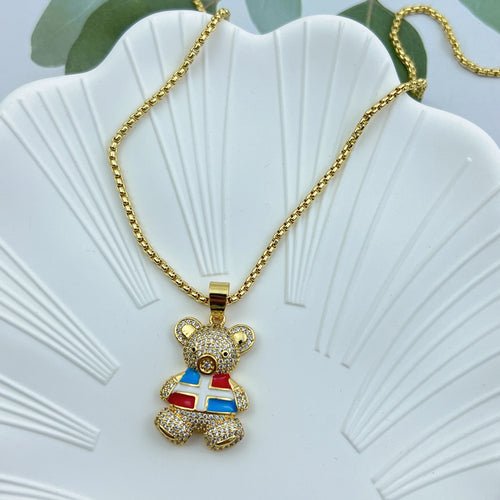 Gold chain necklace with crystal teddy bear pendant featuring a blue and red design.