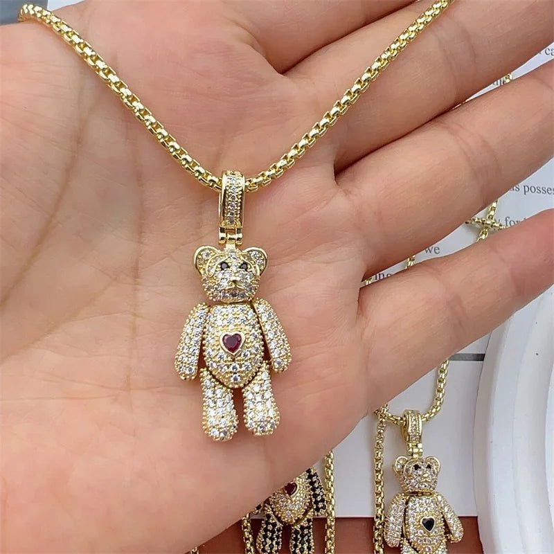 Gold chain necklace with crystal-covered teddy bear pendant and red heart detail.