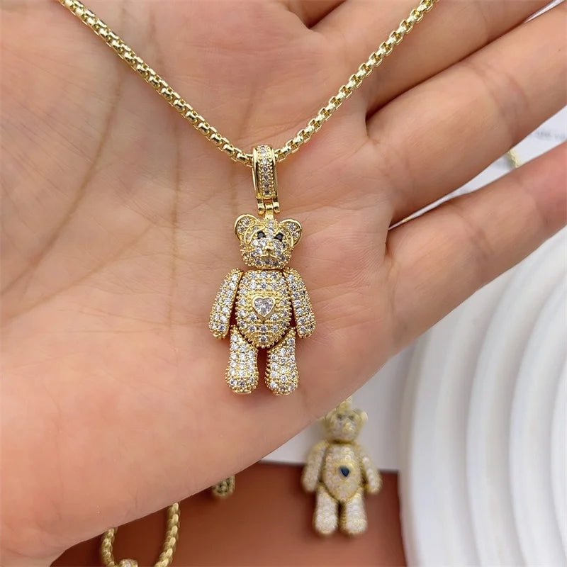 Gold chain necklace with a crystal-covered teddy bear charm featuring a heart detail.