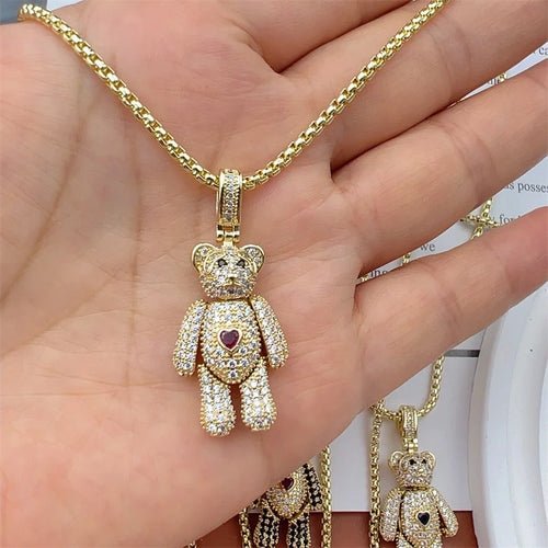 Gold chain necklace with crystal teddy bear charm and red heart detail.