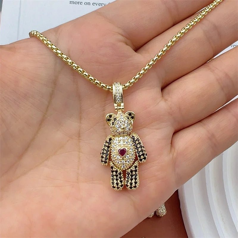 Gold chain necklace with crystal teddy bear pendant featuring a red heart charm.