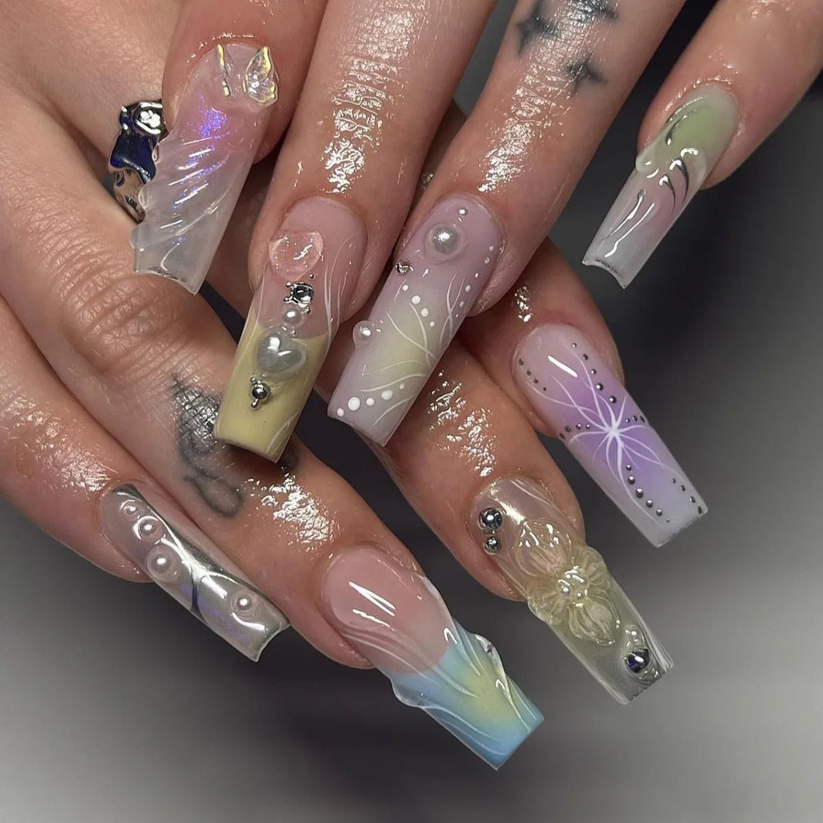 Coffin-shaped press-on nails with rhinestone, pearl, heart, and floral accents.