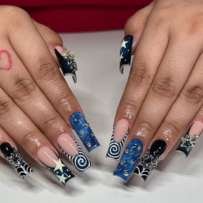 Long coffin press-on nails with star, heart, rhinestone, French tip, and spiral designs.