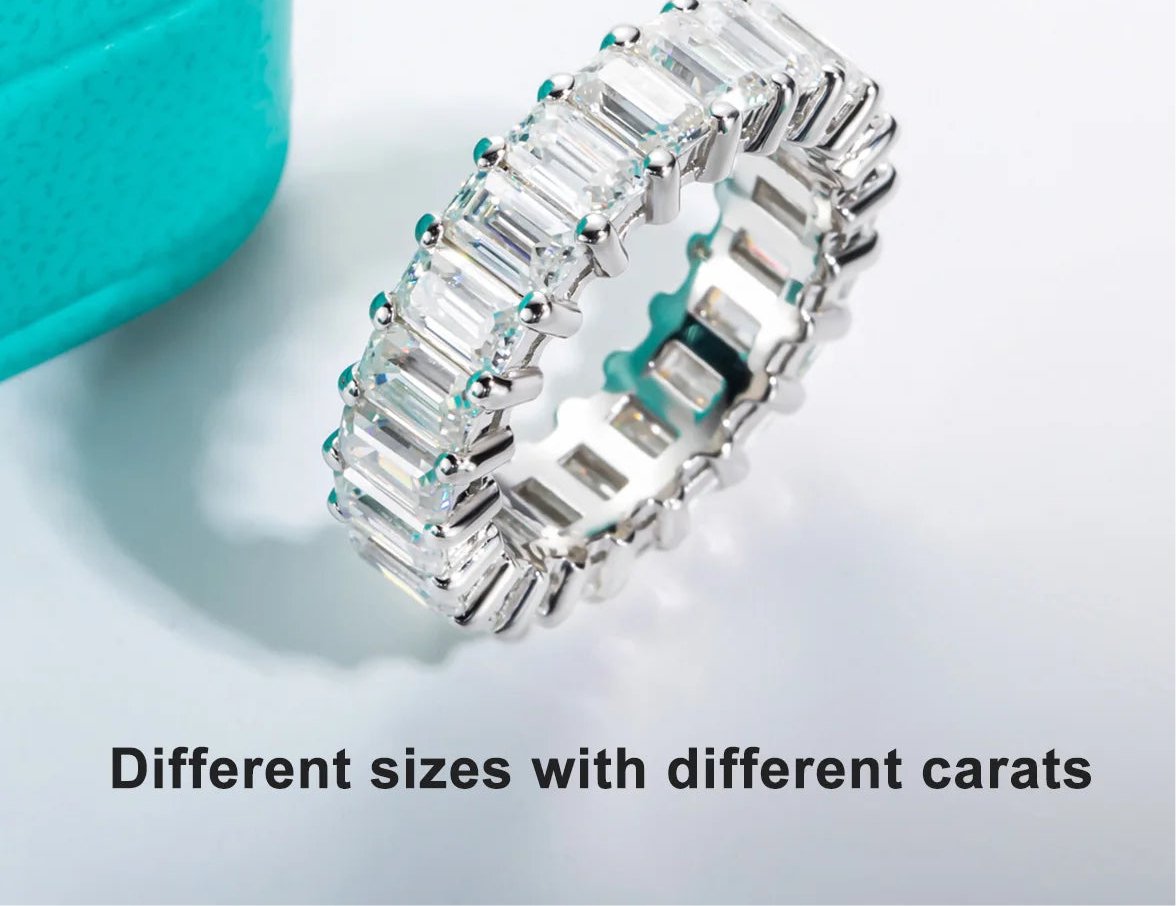 Sterling silver eternity ring with emerald cut moissanite stones.