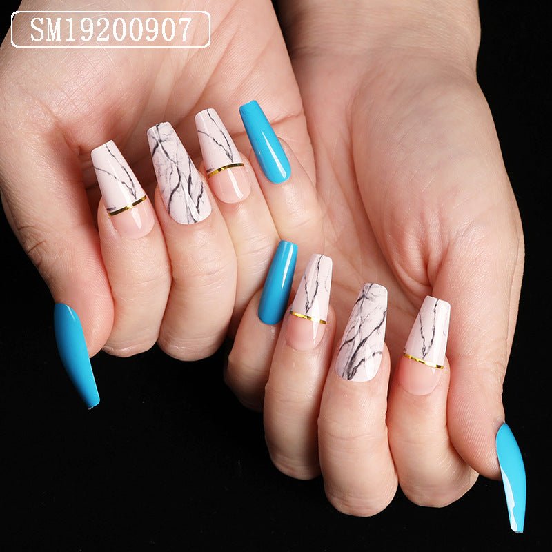 Coffin-shaped fake nails with marble design and blue accents.