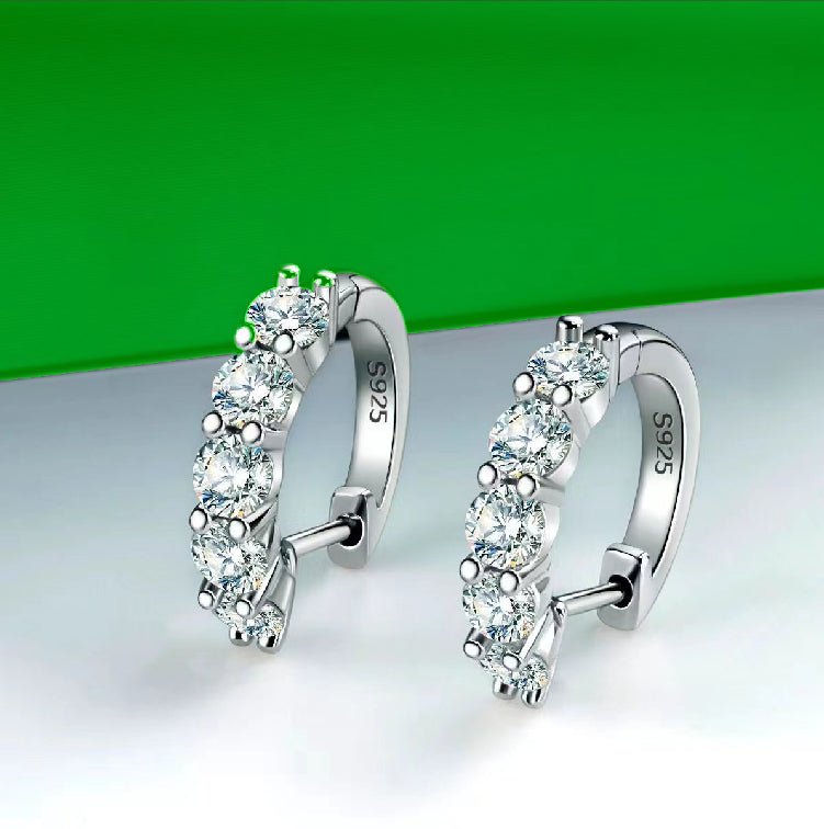 Moissanite hoop earrings. Sterling silver earrings with clear, round-cut gemstones.