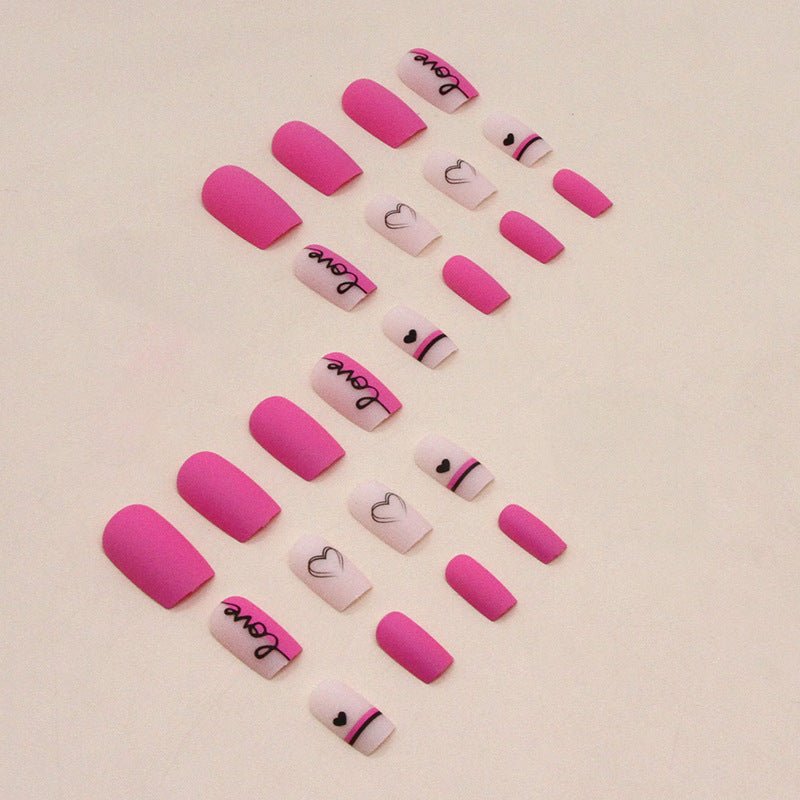 Valentine's Day press-on nails. Pink and white nails with 'Love' and heart designs.