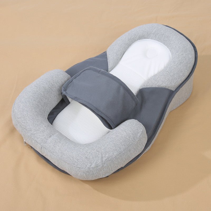 Gray newborn lounger with head support and anti-roll bolster.