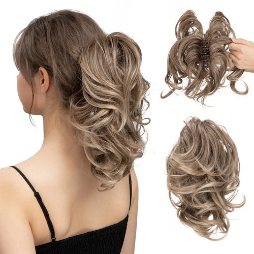 Blonde synthetic claw clip ponytail extension; curly hairpiece bun shown on model.