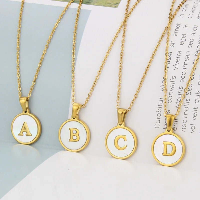 Gold initial necklaces: A, B, C, and D pendants on delicate chains.