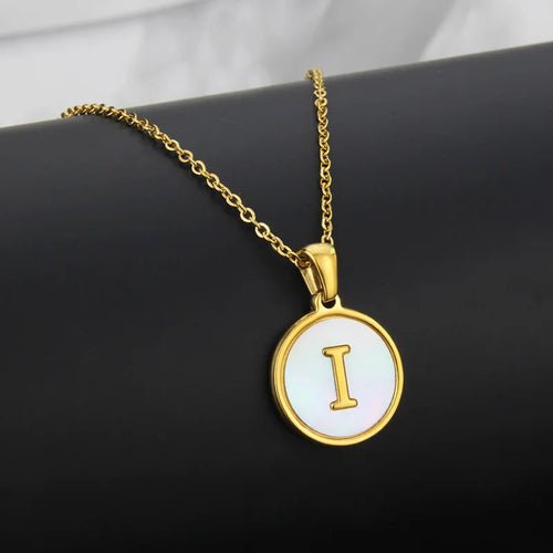 Gold stainless steel necklace with a round pendant featuring the initial 'I'.