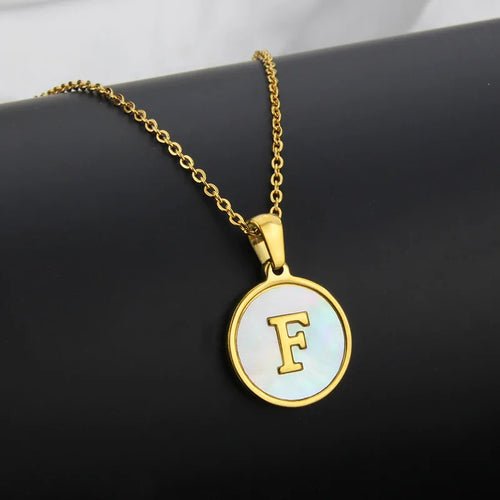 Gold 'F' Initial Necklace: Stainless steel pendant necklace with a round, mother-of-pearl inlay featuring the letter 'F'.