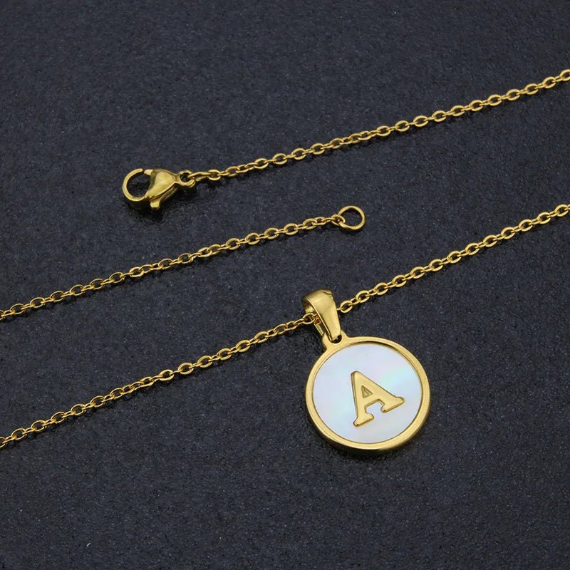 Gold initial 'A' necklace. Stainless steel pendant with mother of pearl inlay on a delicate gold chain.