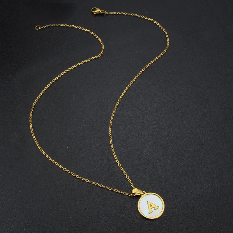 Gold stainless steel necklace with white circle pendant featuring the letter A.