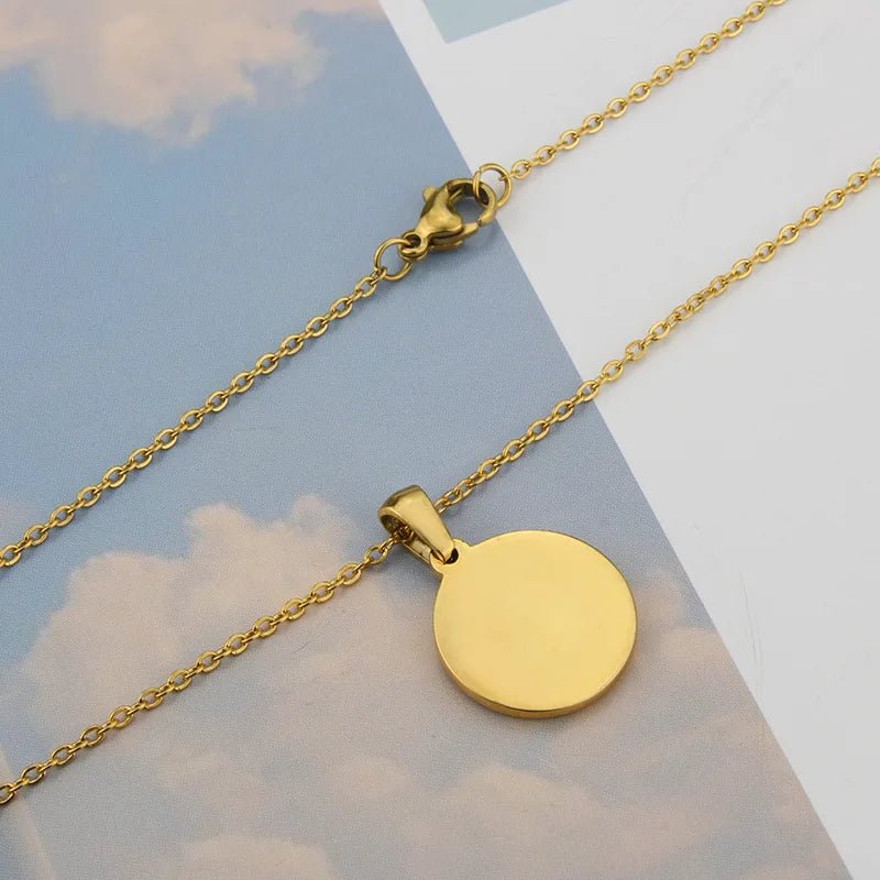Gold circle pendant necklace on a delicate chain. Stainless steel initial necklace for women.