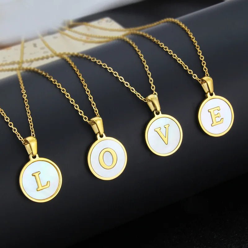 Gold initial pendant necklaces spelling LOVE. Stainless steel circle initial necklaces for women.