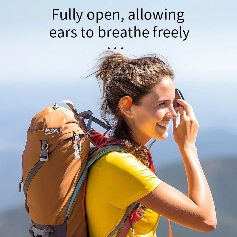 Open ear wireless headphones shown on a hiker with a backpack, ear-hanging, non-in-ear style.