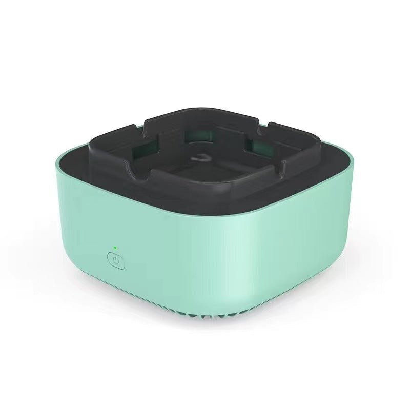 Mint green portable air purifying ashtray with black top.