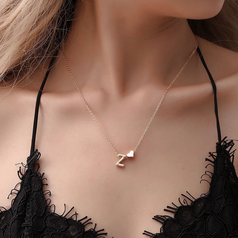 Gold initial 'Z' necklace with heart charm detail.
