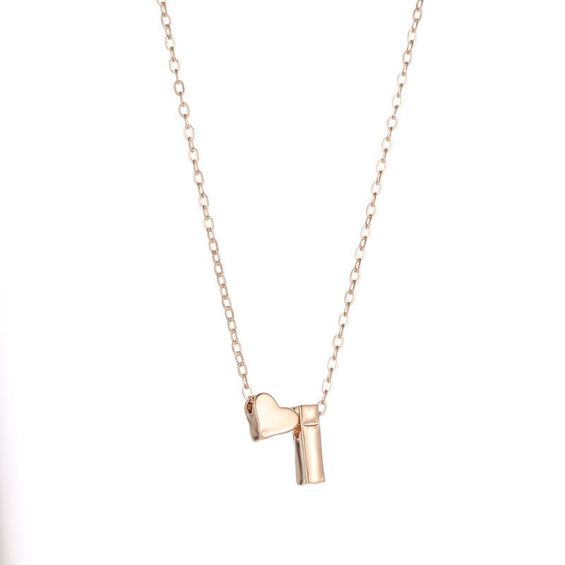 Gold heart and initial 'I' pendant necklace.